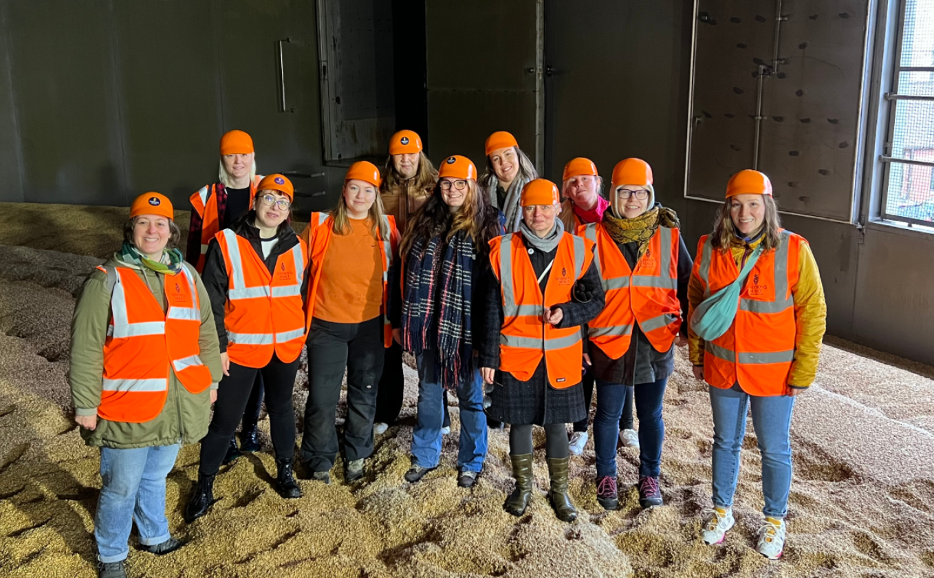 A group of women in high-vis in a malt house
