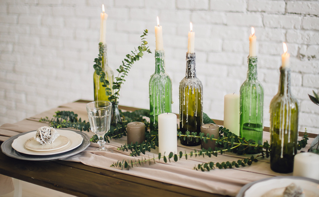 Wine bottles with candles put in the ends