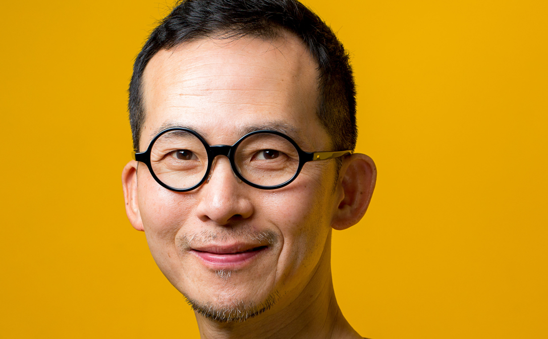 A person in front of a bright yellow background