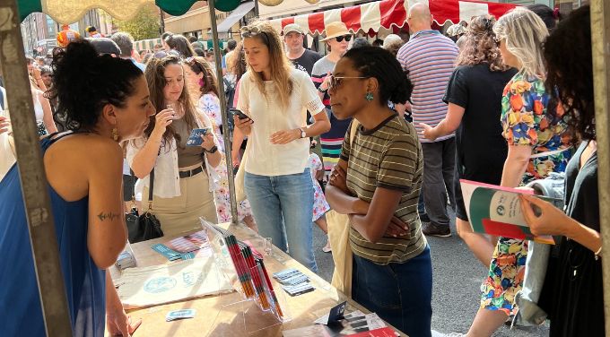 Guests talk to staff on WSET School London stand at Bermondsey Street Festival 2023